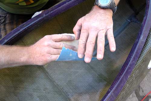 Sanding the interior of the kayak in the seat fitting area