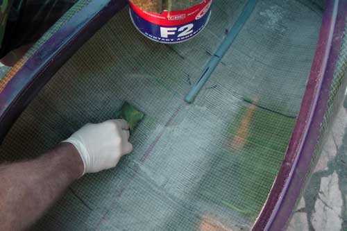 Applying contact adhesive to the interior hull