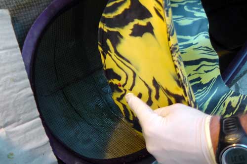 Placing the Bumfortable into the kayak, ensuring the central mark on the seat lines up with the central mark on the seat